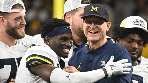 Jim Harbaugh celebrates Michigan’s 2023 Big Ten championship with his players.